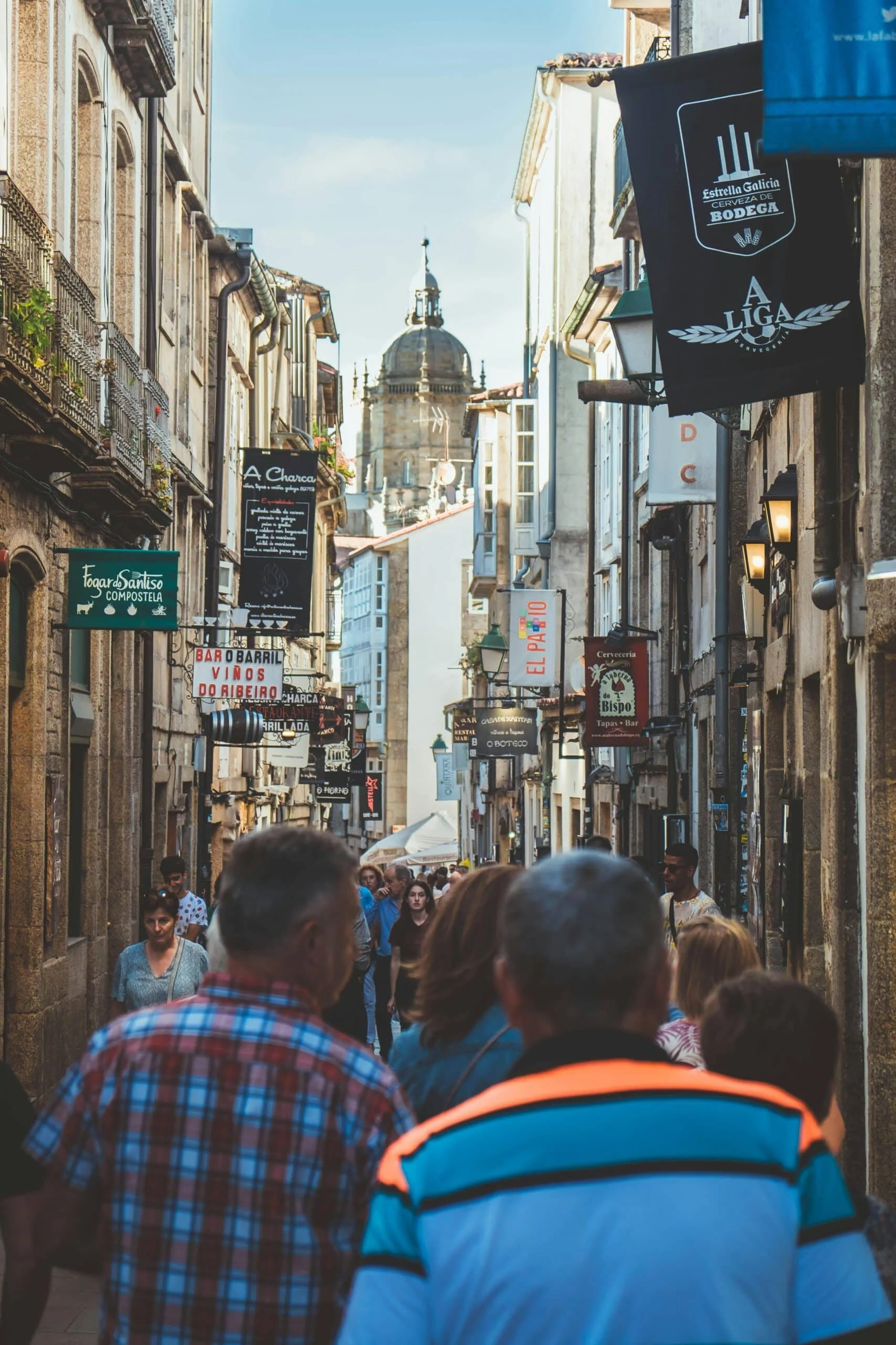 Historic streets of Santiago de Compostela with pilgrims and local city atmosphere
